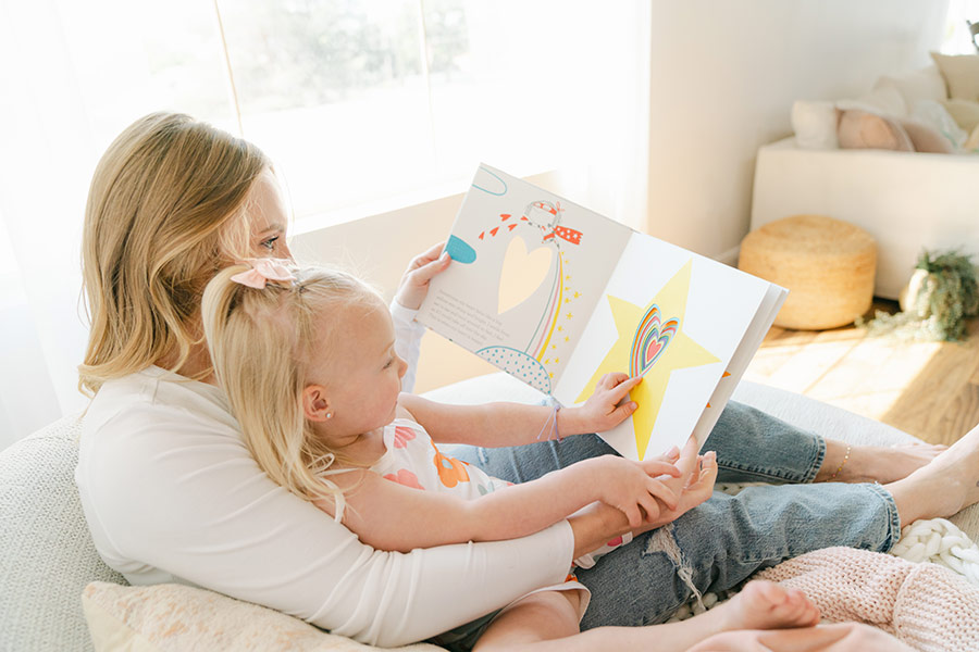 Kari Holding Child Reading Book